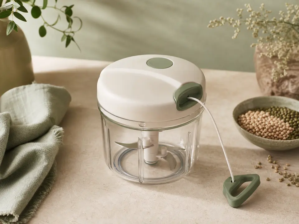 Compact clear manual food chopper with enclosed blades