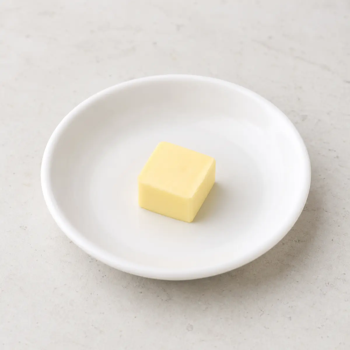 Small pat of plain butter on a saucer