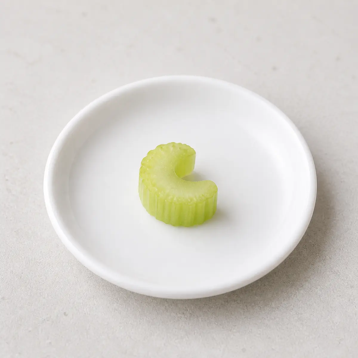 Tiny plain celery slice on a saucer