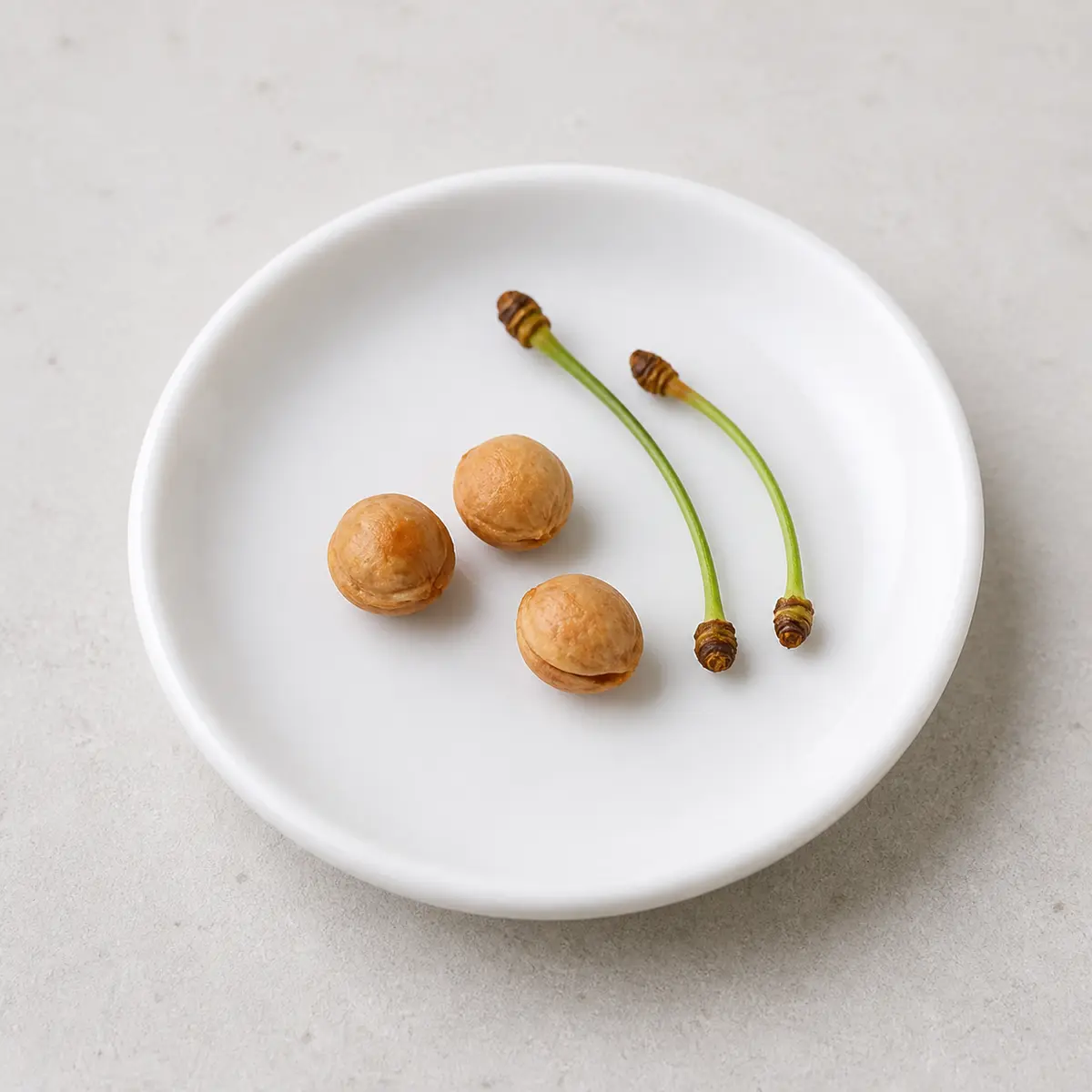 Cherry pits and stems on a saucer