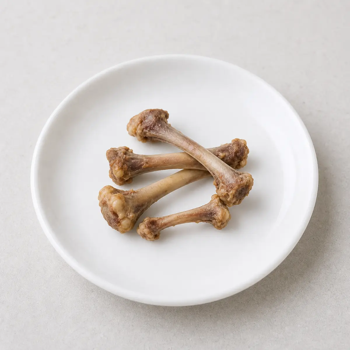 Cooked chicken bones on a plate