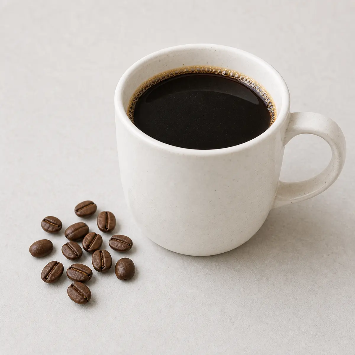 Black coffee cup with coffee beans on a counter