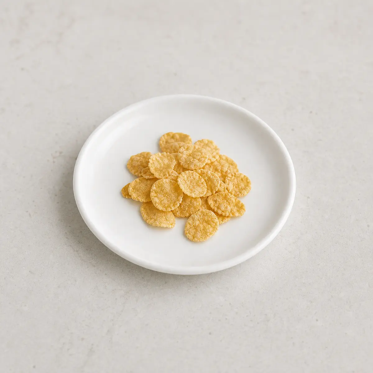 Plain dry cornflakes on a saucer