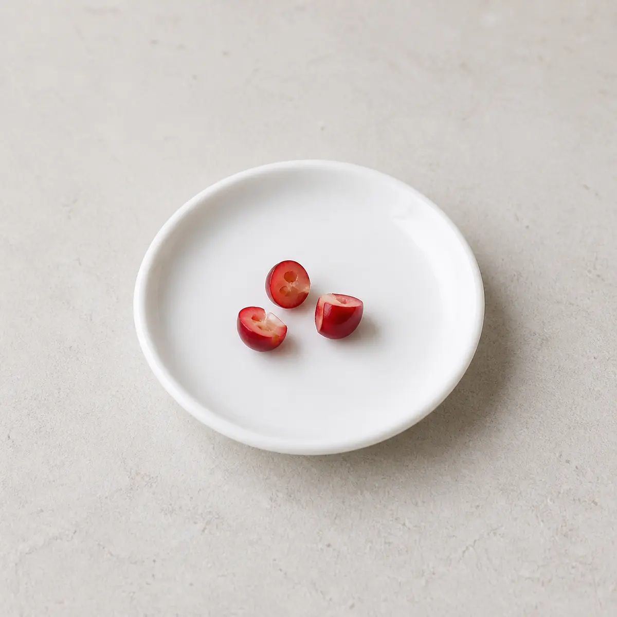 Tiny plain cranberry pieces on a saucer