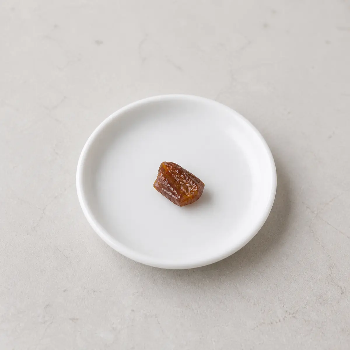 Tiny pit-free date piece on a saucer