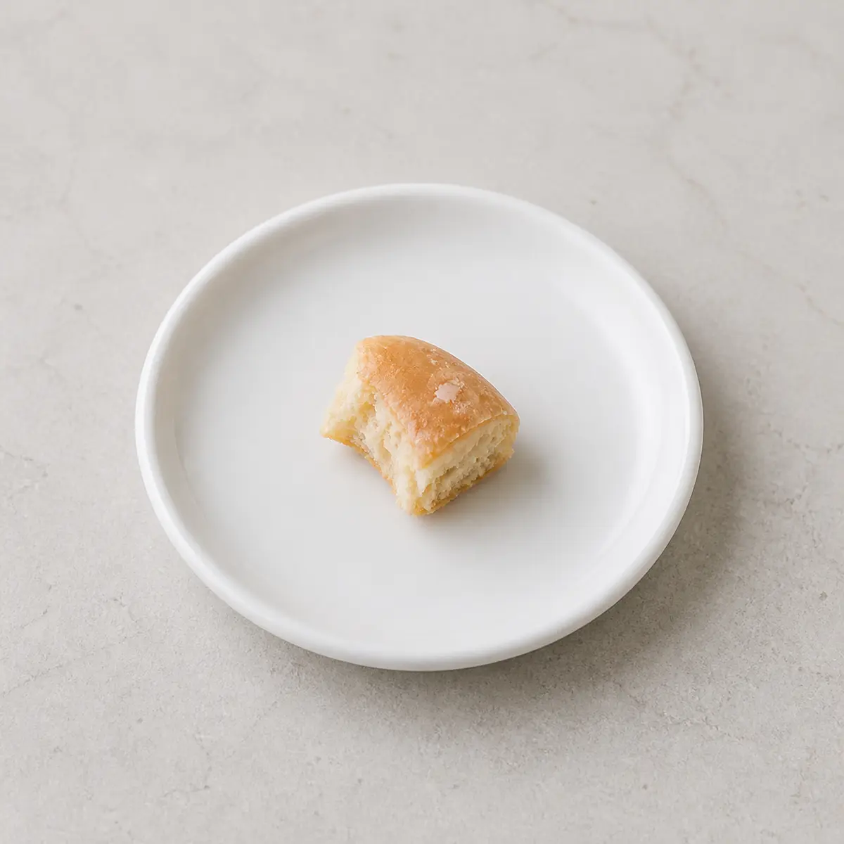 Small plain glazed donut piece on a plate