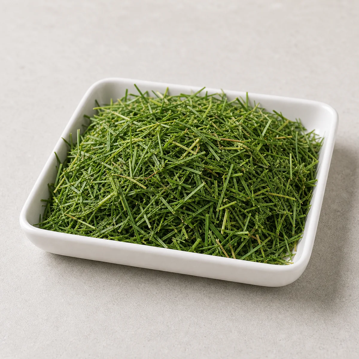 Fresh lawn grass clippings in a small tray