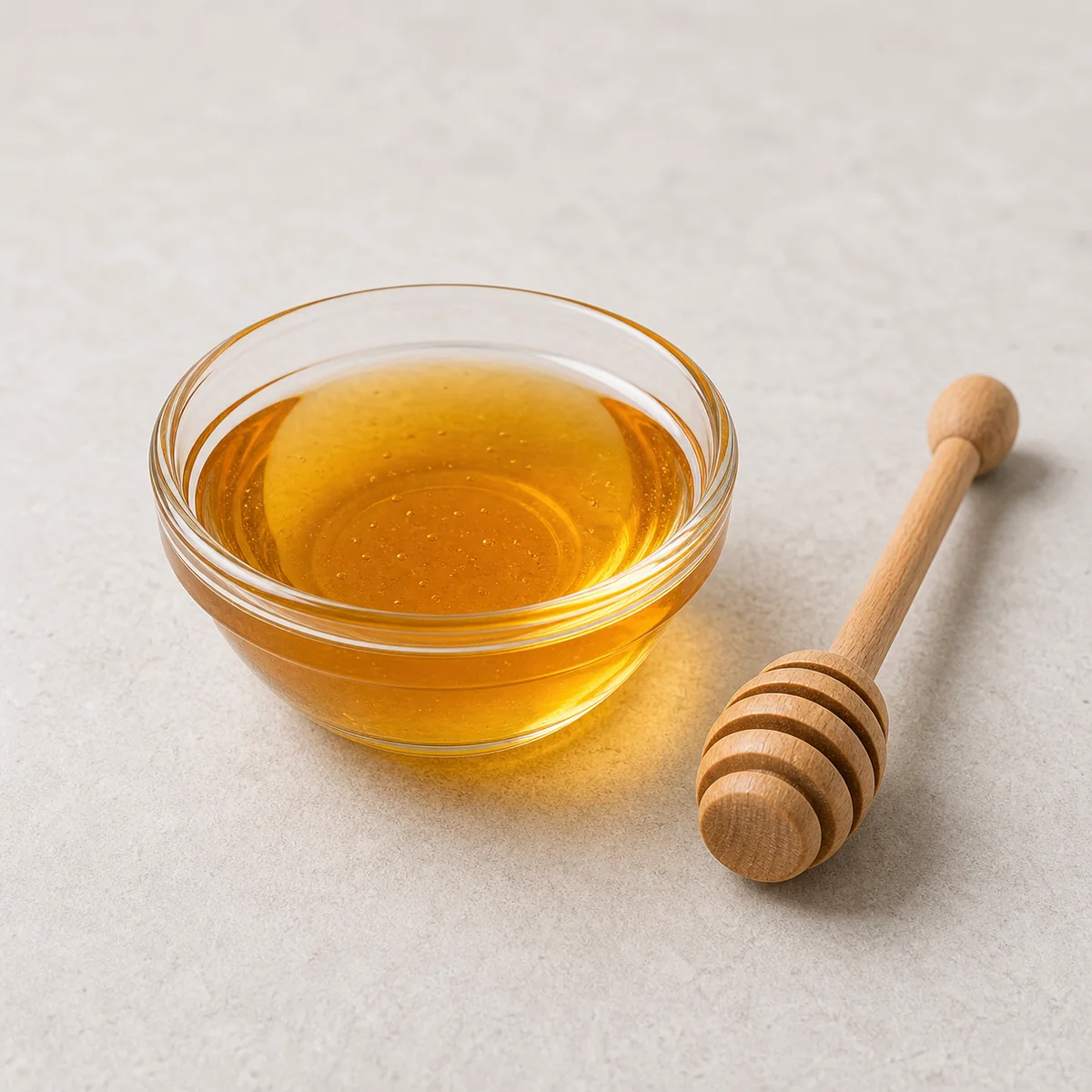Small dish of honey with a honey dipper