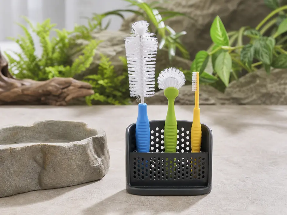 Small bottle and dish brushes kept together for pet-food cleanup.