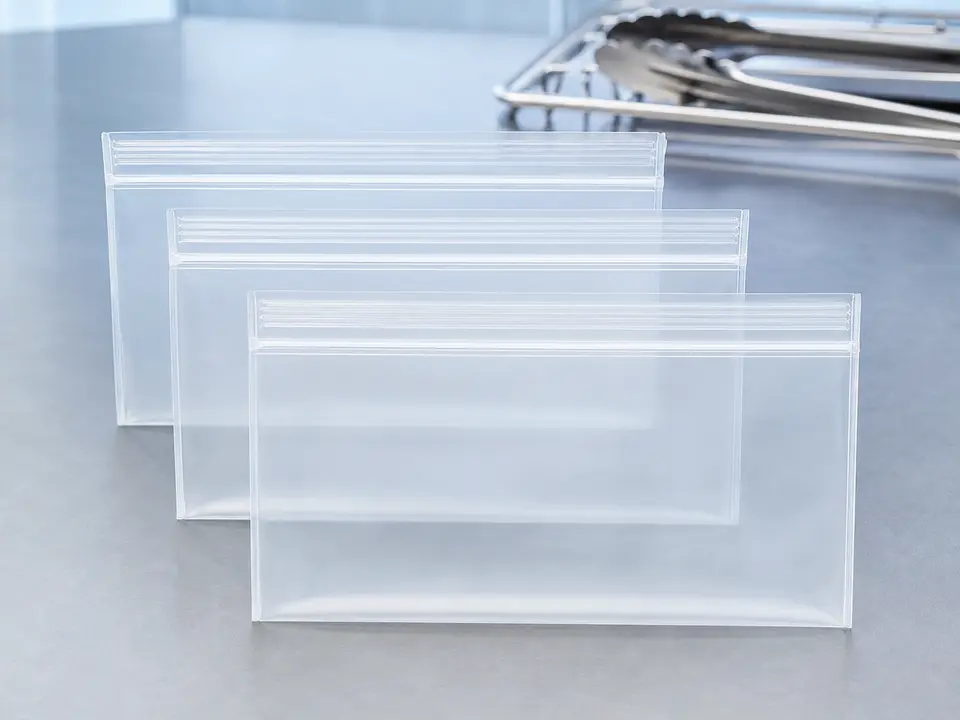Reusable freezer-safe storage bags arranged for labeled dedicated pet-food storage.