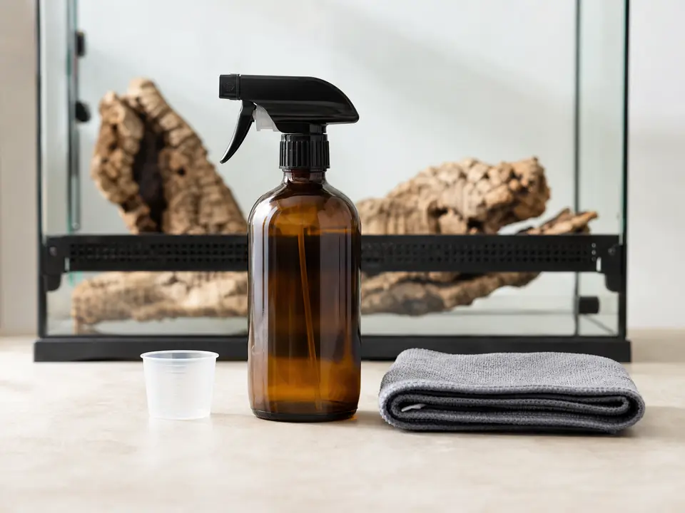 Unbranded pet-safe cleaning spray beside a clean reusable cloth.