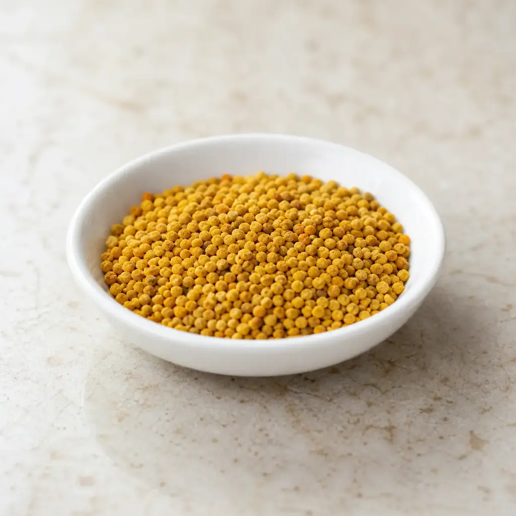Plain bee pollen on a clean unbranded surface for a reptile food-safety check.