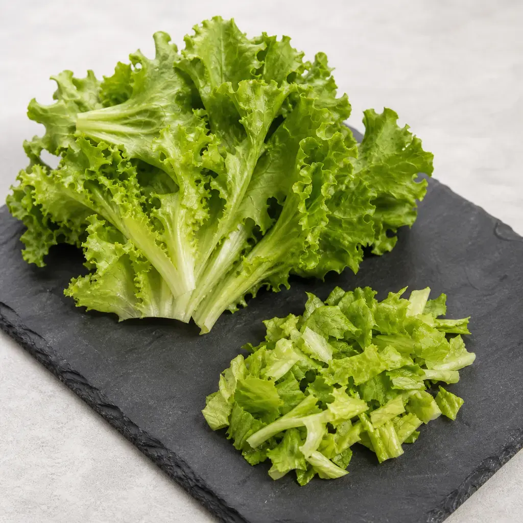 Plain escarole on a clean unbranded surface for a reptile food-safety check.