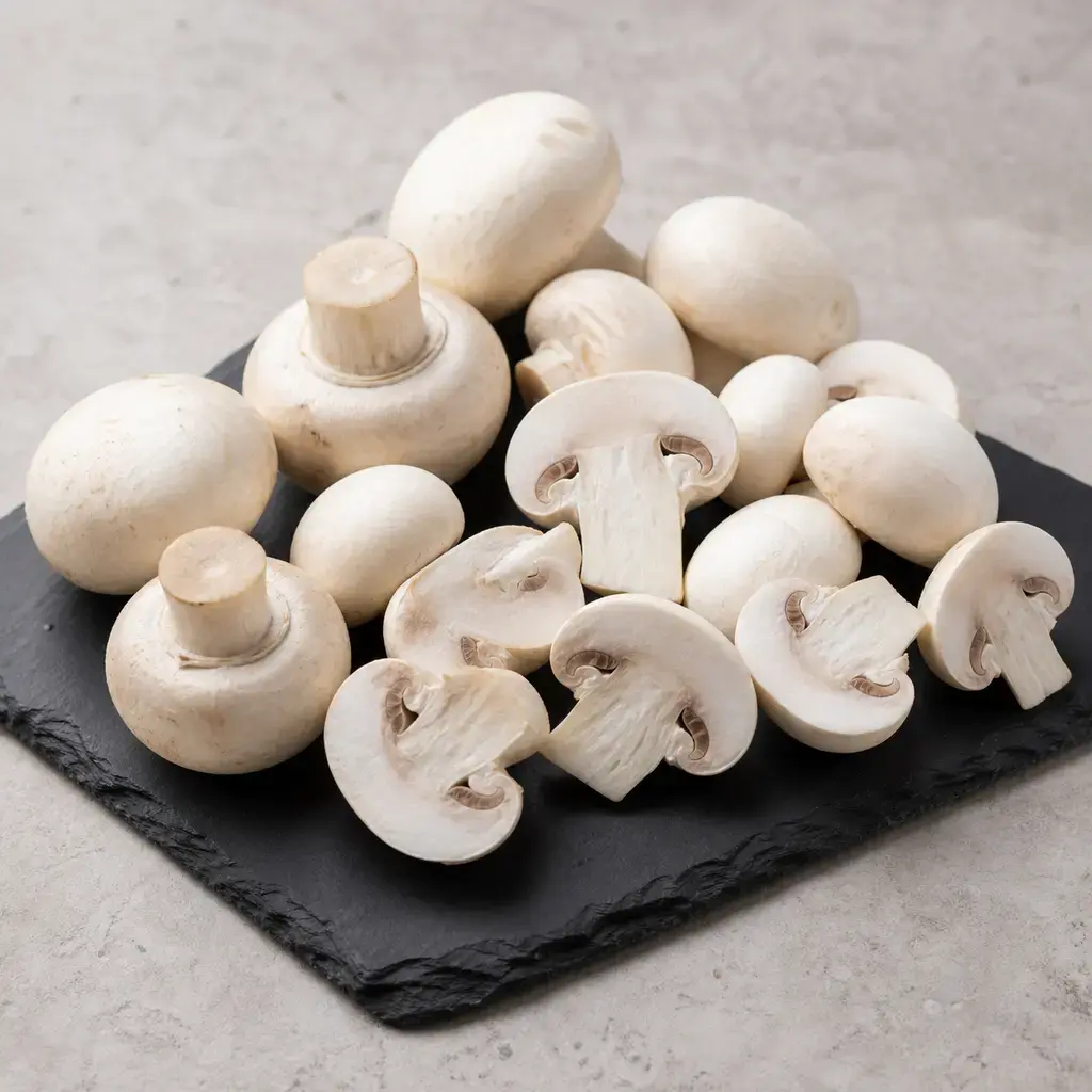 Plain mushrooms on a clean unbranded surface for a reptile food-safety check.