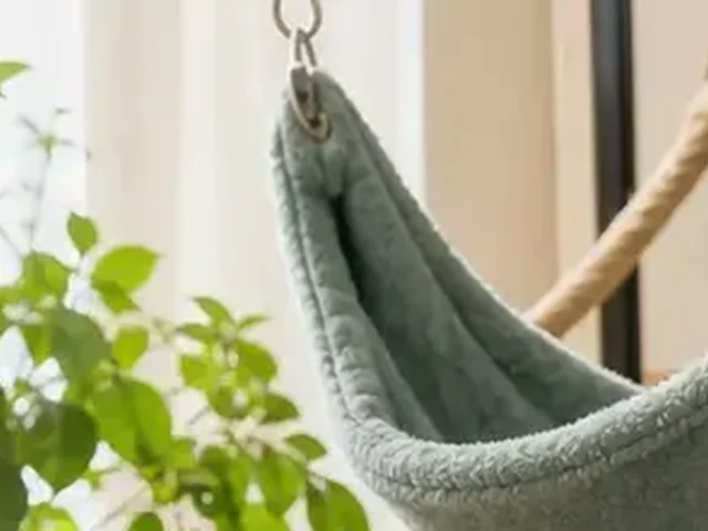 Washable hammock hanging in a ferret cage.