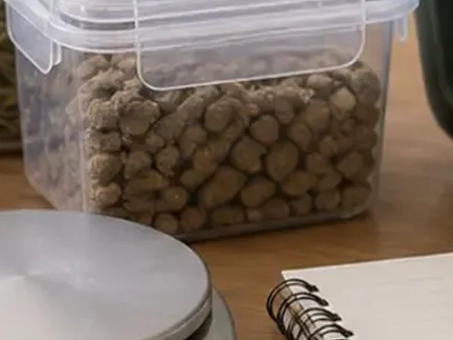 Sealed container of guinea pig pellets beside care supplies.