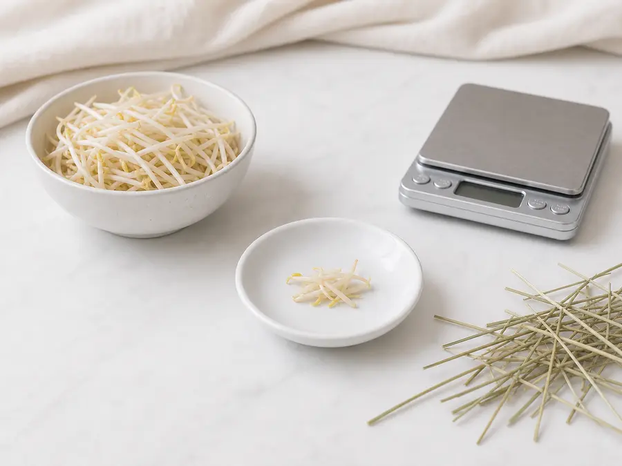 Tiny fresh bean sprout portion on a saucer beside bean sprouts, hay, and a gram scale.